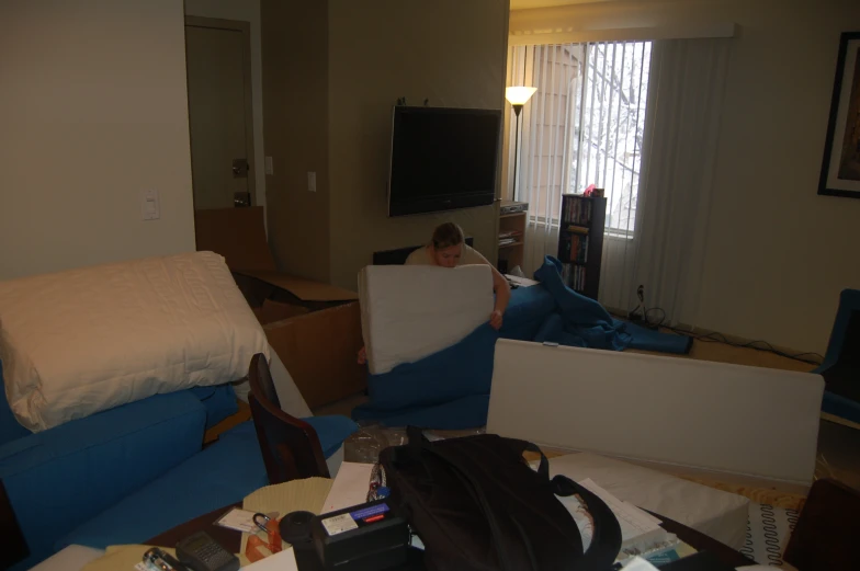 a man holding a pillow in a living room area