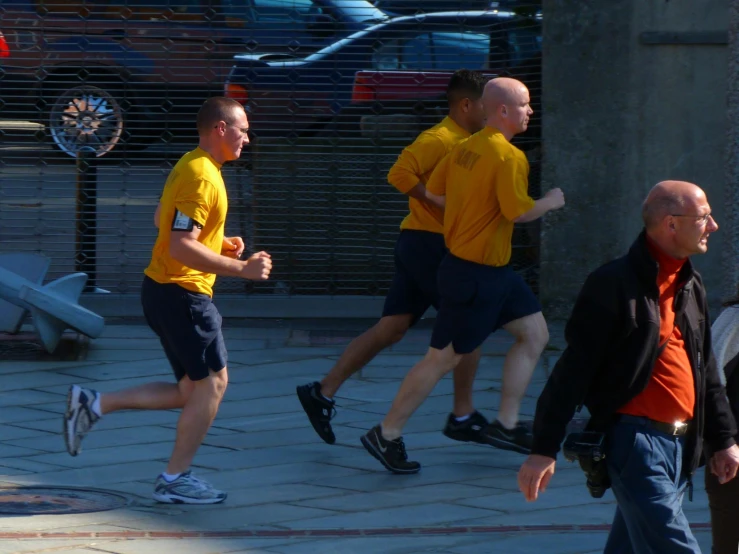 a group of people running on the street together