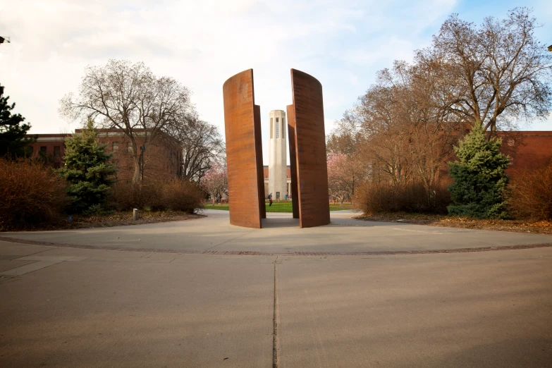 there is a tall sculpture that is on a cement area