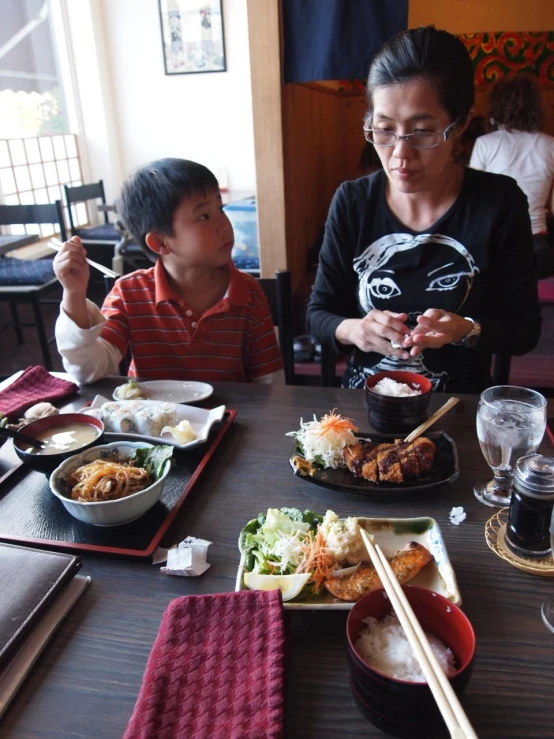 woman sitting next to a  eating some food