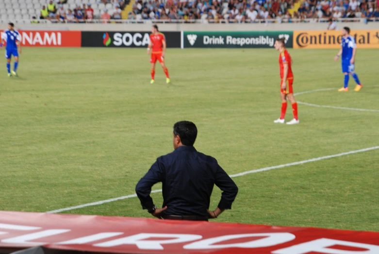 soccer players stand on a field with their teams standing