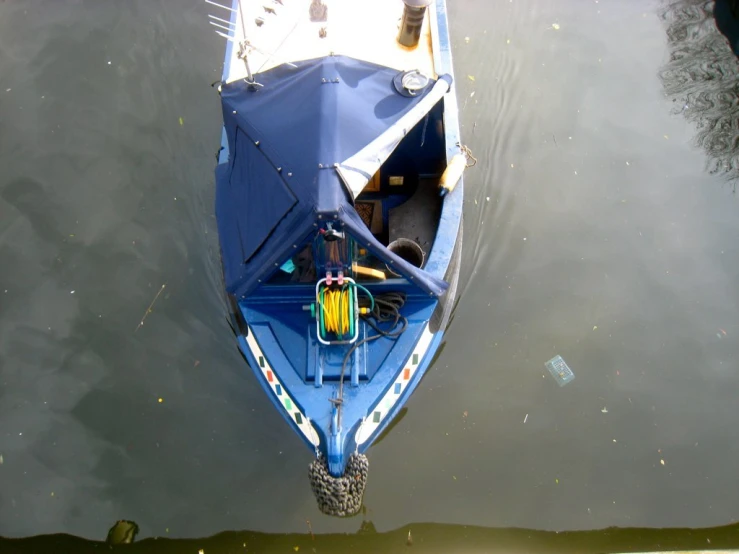 a blue motor boat with a red life guard stand at the bottom