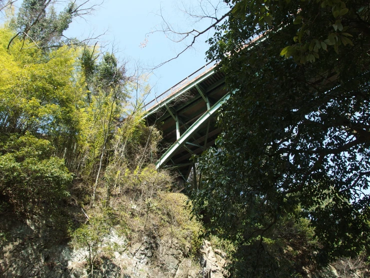 a bridge is surrounded by trees and hills