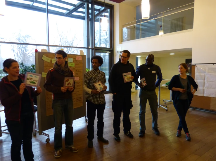 group of people standing around a large display