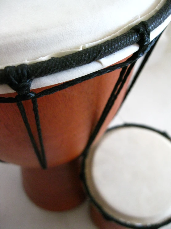 small round piece of cloth on top of a wooden drum