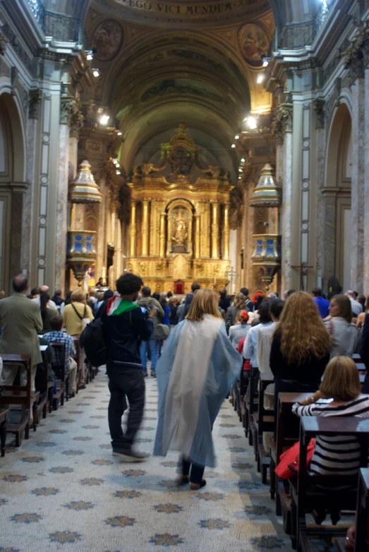 a group of people sitting in church with lights on