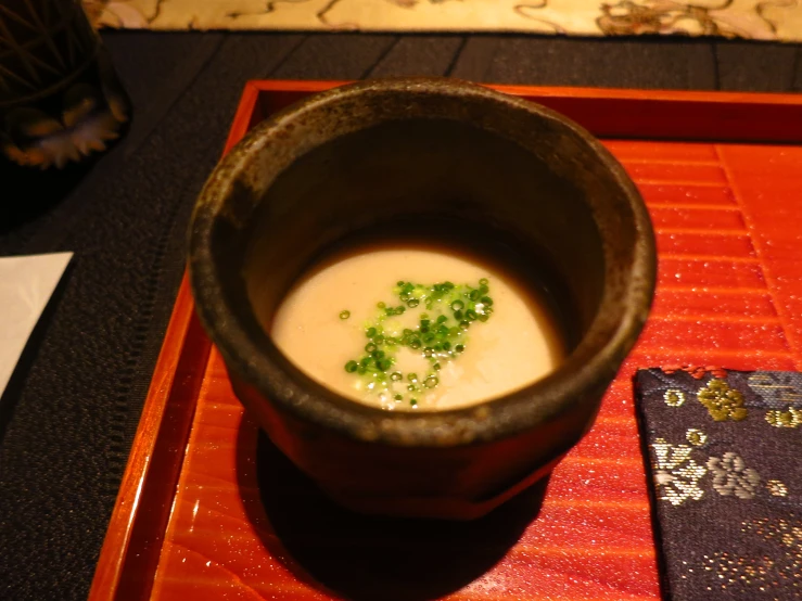 there is a large bowl of soup and a small cloth