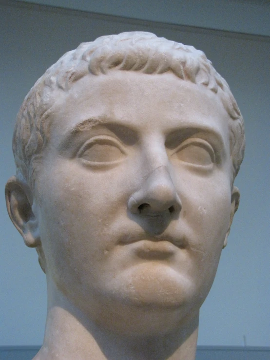 an ancient greek bust of a young man's head