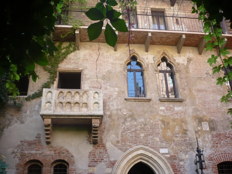 an old building with two balconies and arched windows