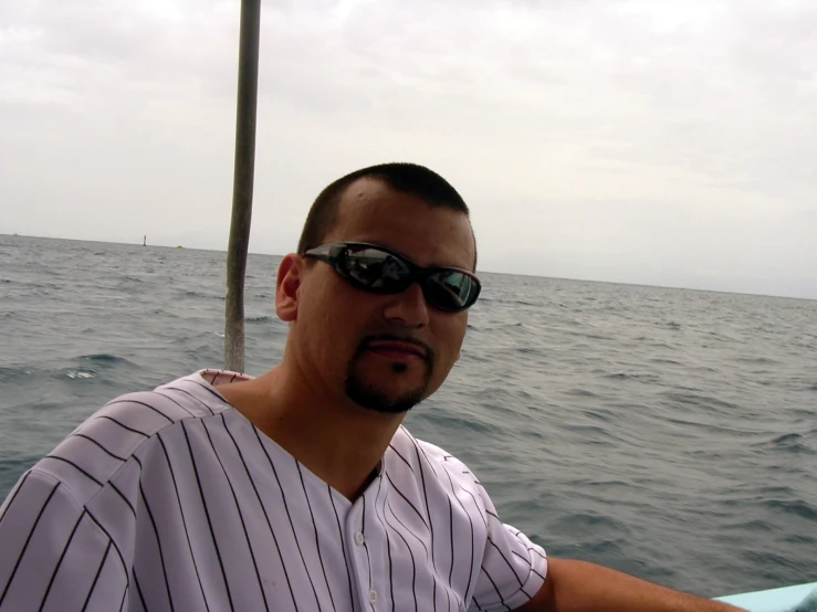man on a boat with sun glasses at sea