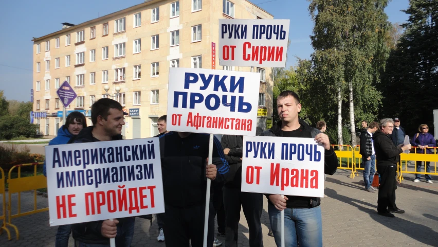 several men holding signs on a city street