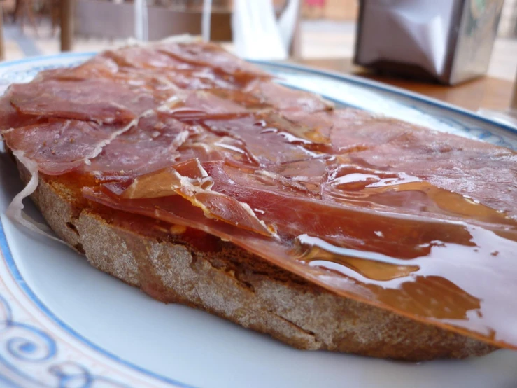 slices of bacon sitting on top of a toast with chocolate syrup