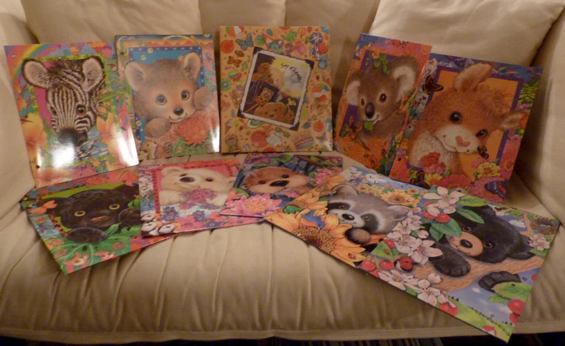 a sofa has a bunch of card decks of animal designs on them