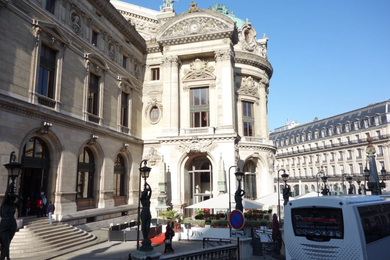 two buses are parked in front of buildings