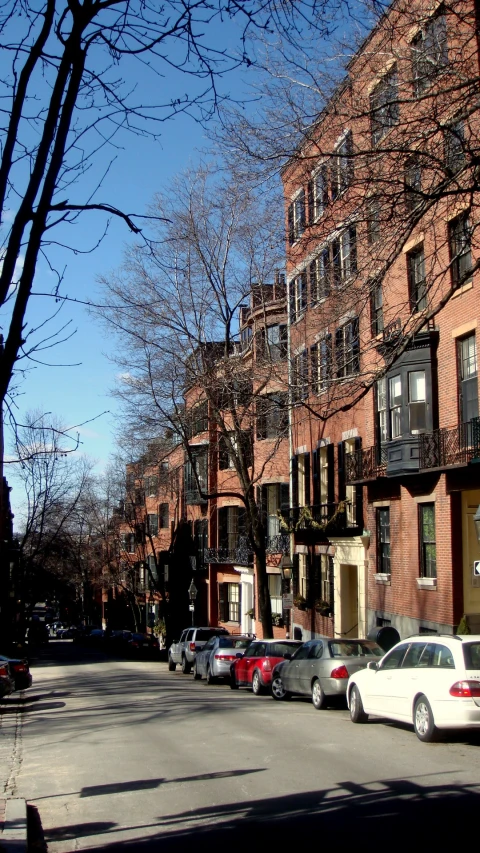 two white cars are parked on the street