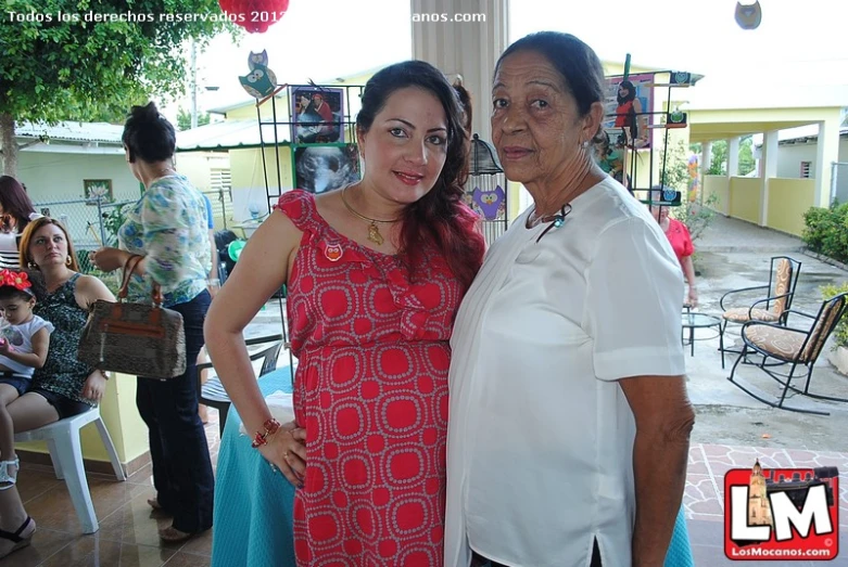 two women are standing next to each other and posing for a po