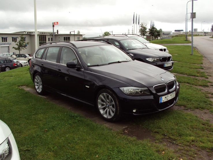 three bmws parked on the side of a road