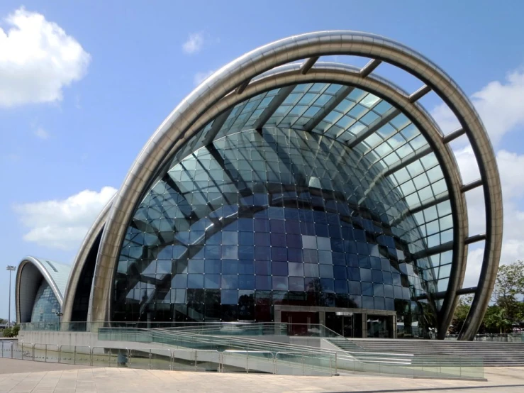 an unusual building with a huge circular window in front