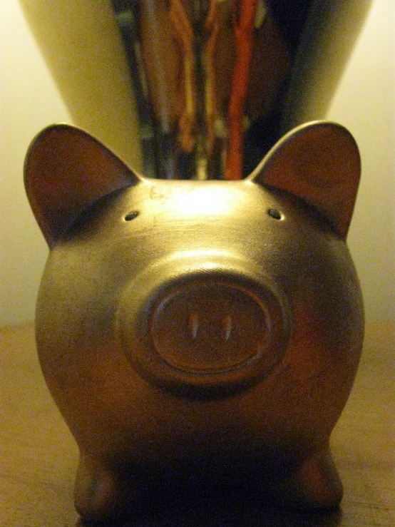 a metal pig figurine sits on the desk
