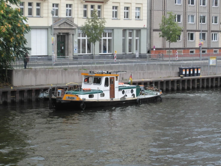 a large boat traveling on the water near some tall buildings