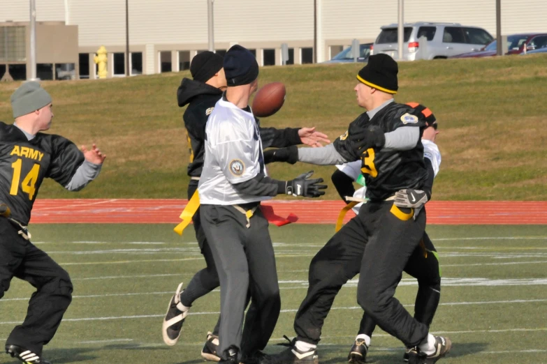 a bunch of s playing football on the field