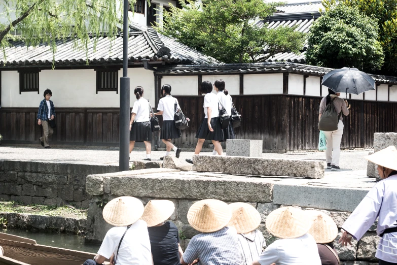 people are sitting on some stone steps near a waterway