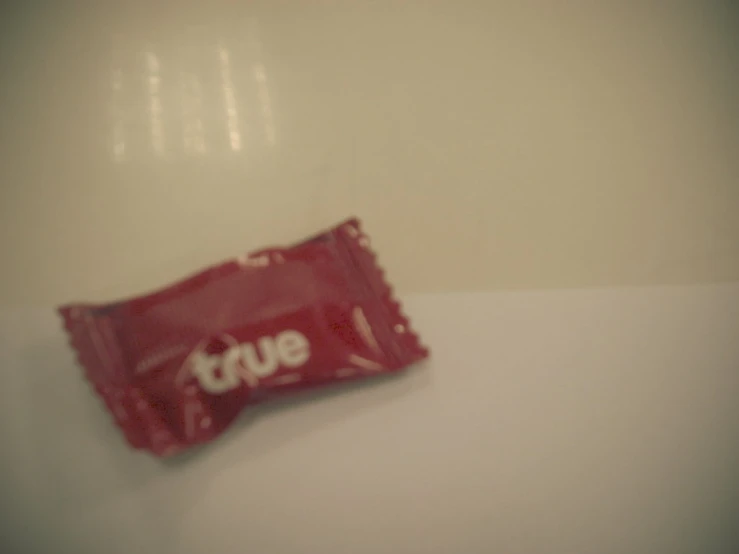 a couple of chips on a table with the word true in a bag