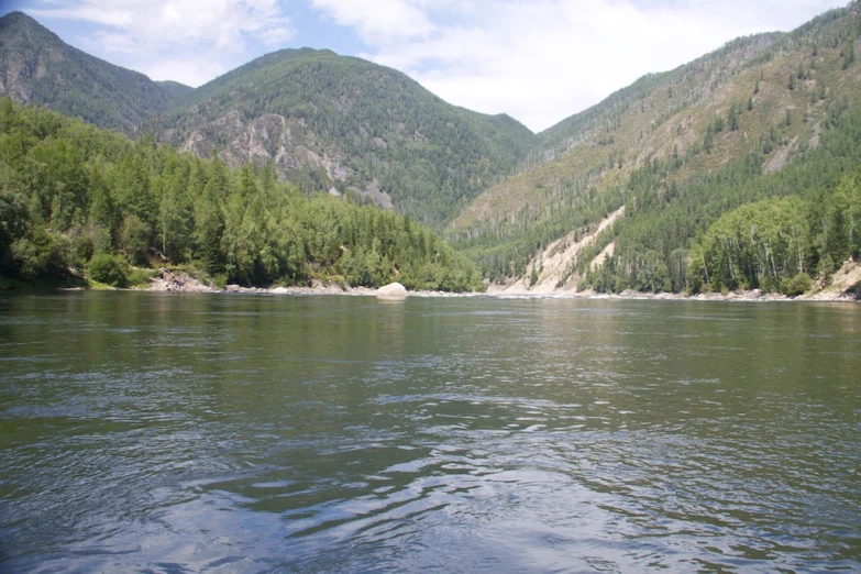 a river with a few large hills on the side