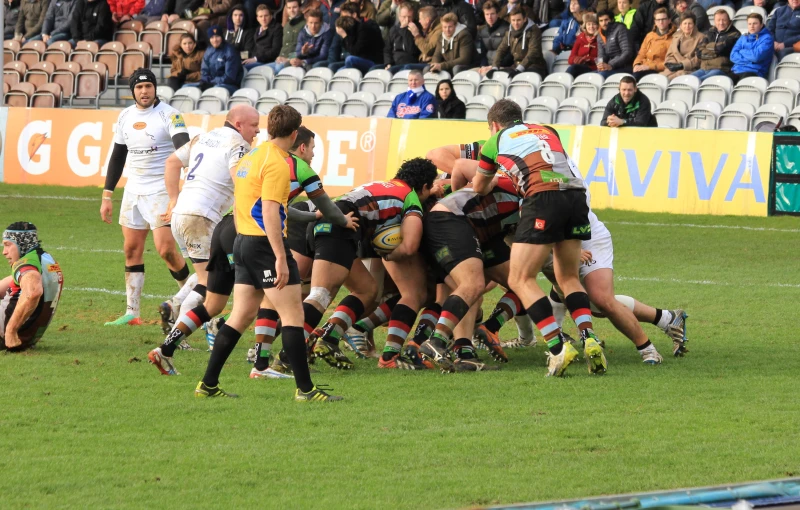 a group of rugby players huddle together on the field