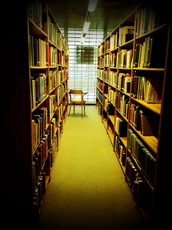 a liry with tables and chairs full of books