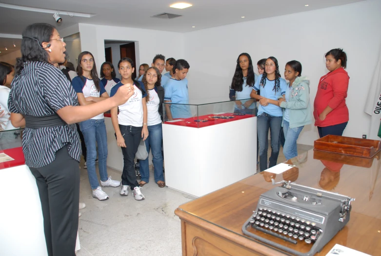 a group of people looking at soing in a room