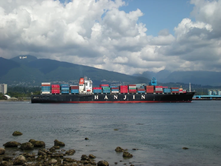 a large ship is at dock with some smaller boats