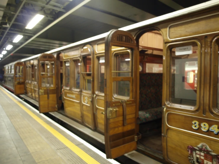 two old trains are pulled into the station
