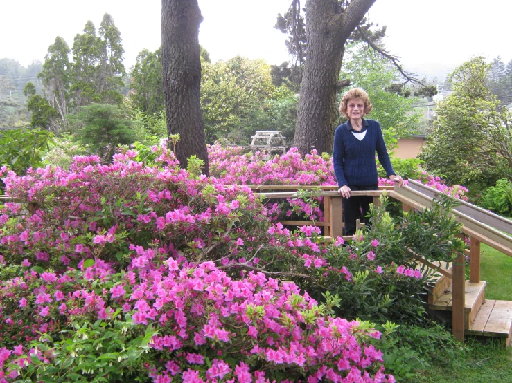 the woman is standing outside of the garden