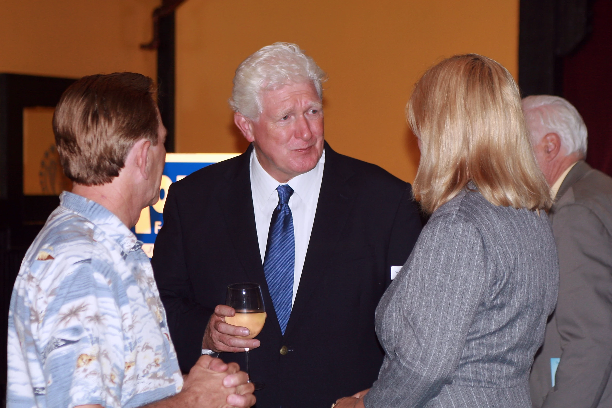 several people talking and having drinks at a party