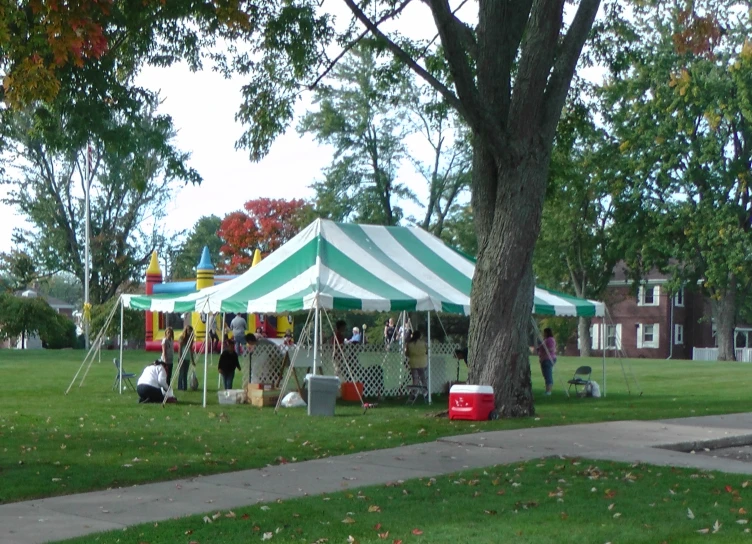 people at a tent set up under a tree