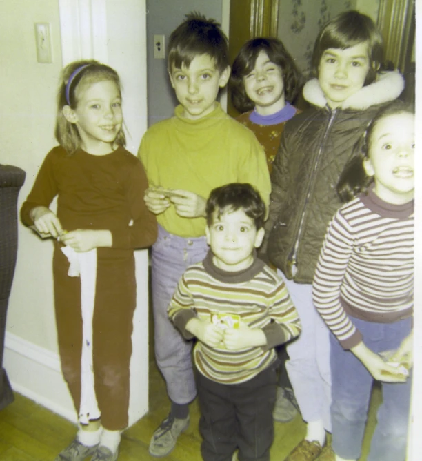 a group of s posing for a picture in the living room