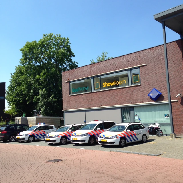 a number of parked cars outside of a building