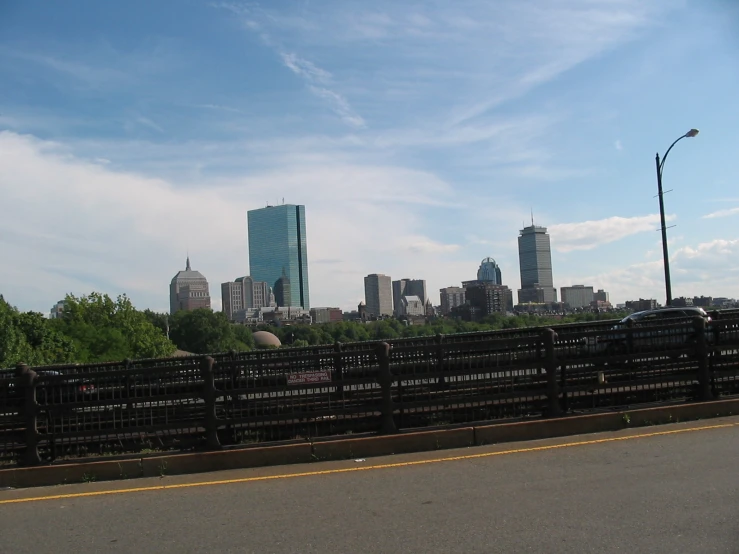 the skyline is shown with skyscrs as seen from across a road