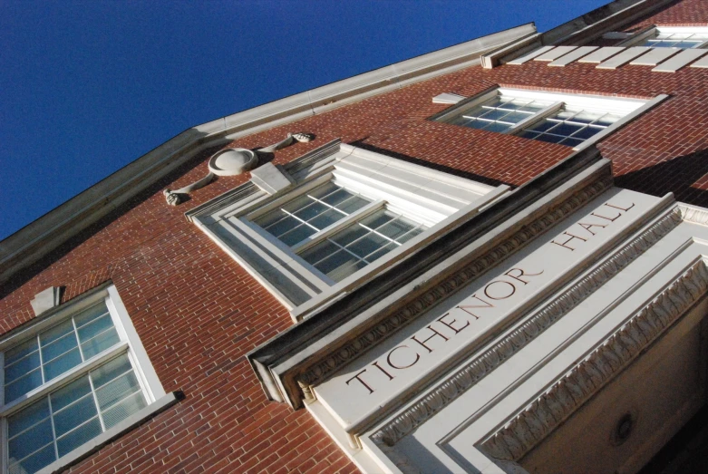 a brick building is shown with a sign on it