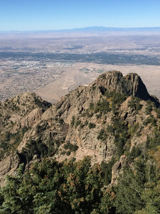 view from top of a mountain with the city in the distance