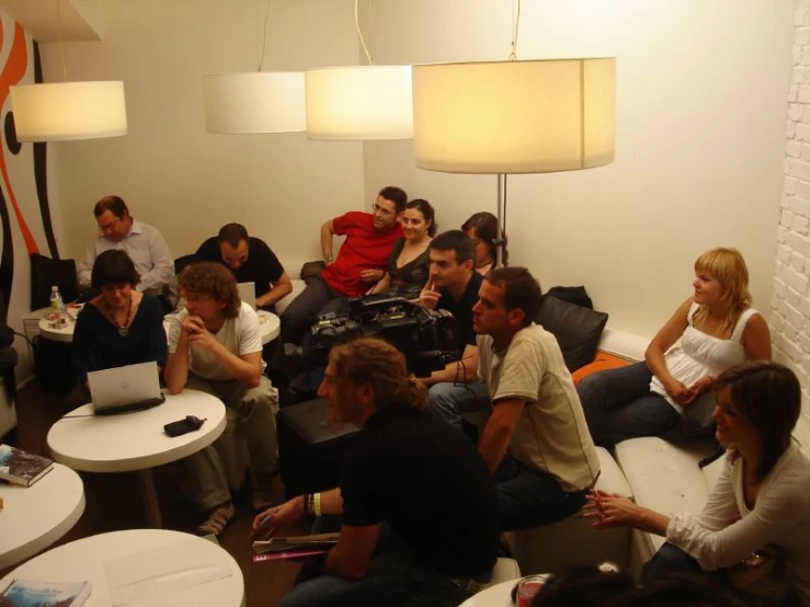 a group of people sitting around a room