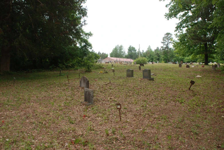 an empty cemetery in the forest near a country house