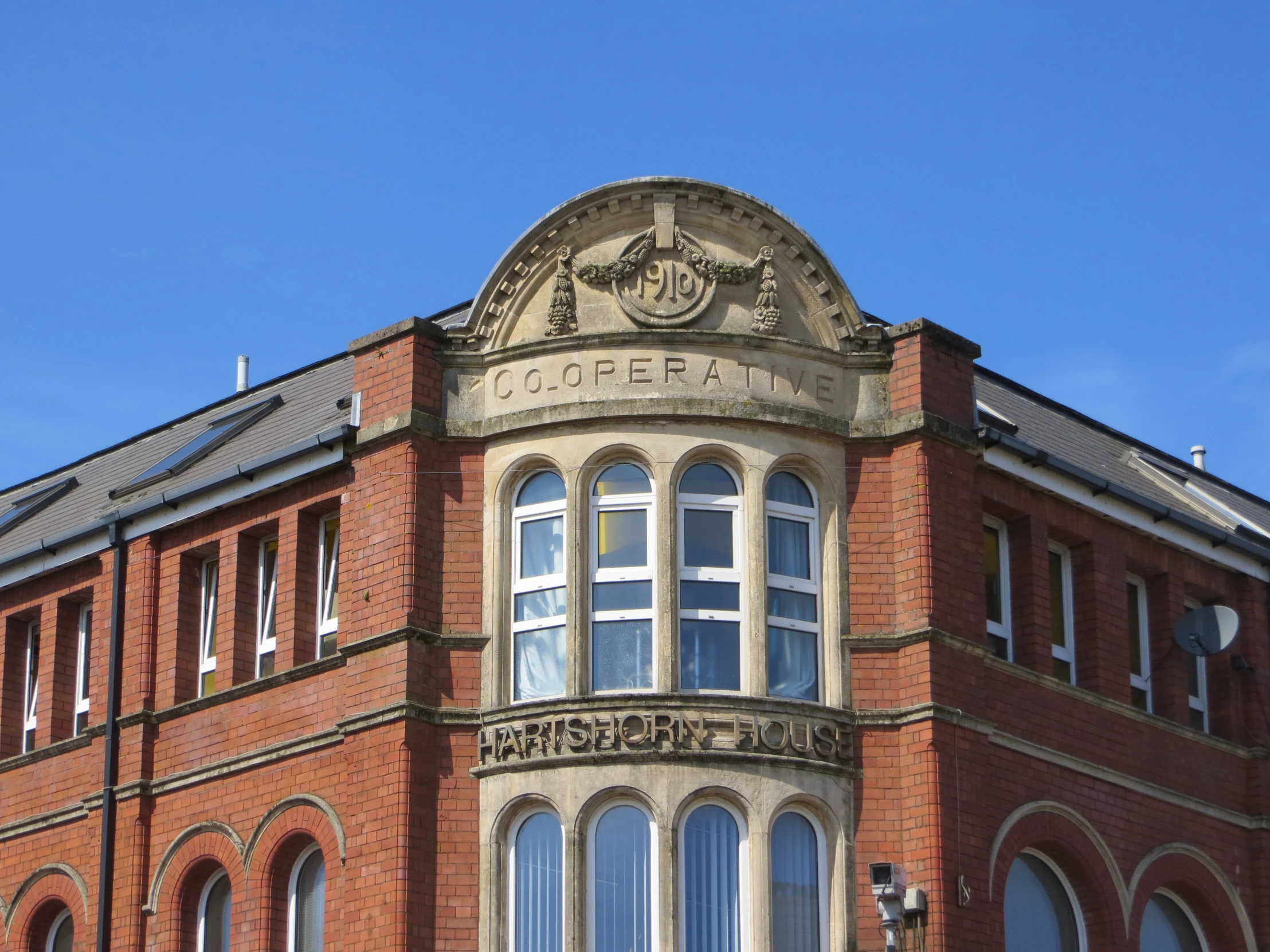 the top of a tall brick building with windows