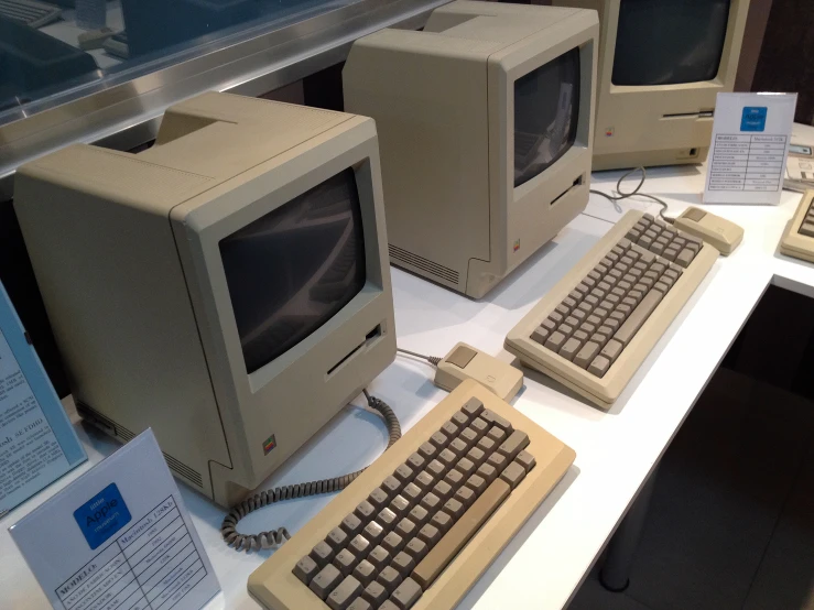 older computers on display together on a glass table