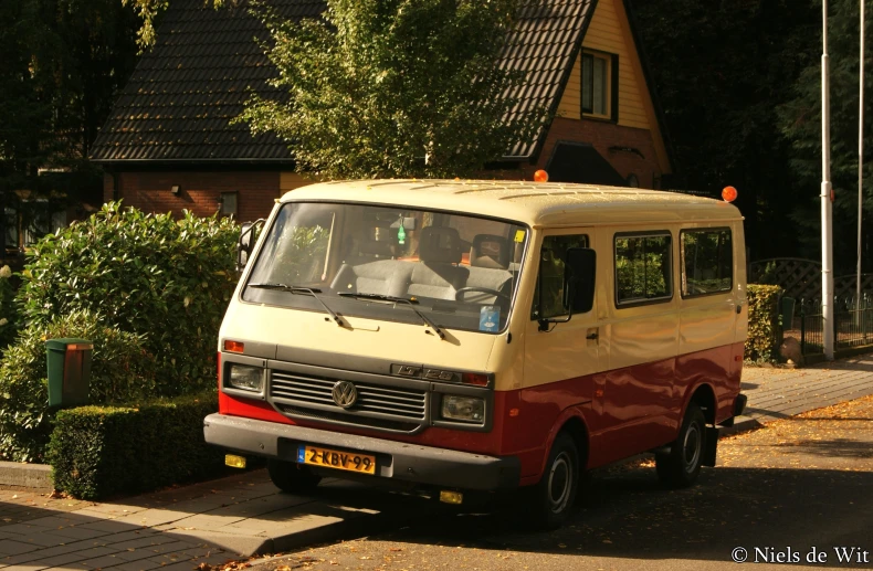 an old van sits parked on the side of a street