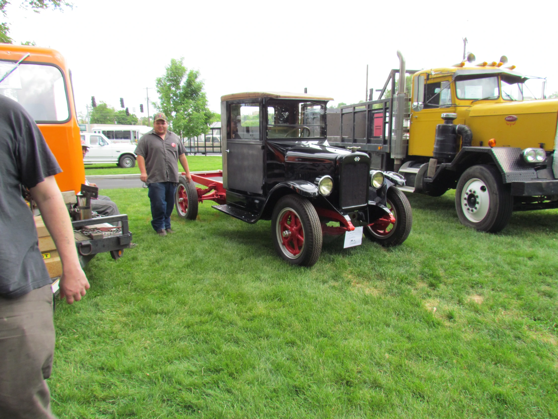 a yellow and a black truck are in a field