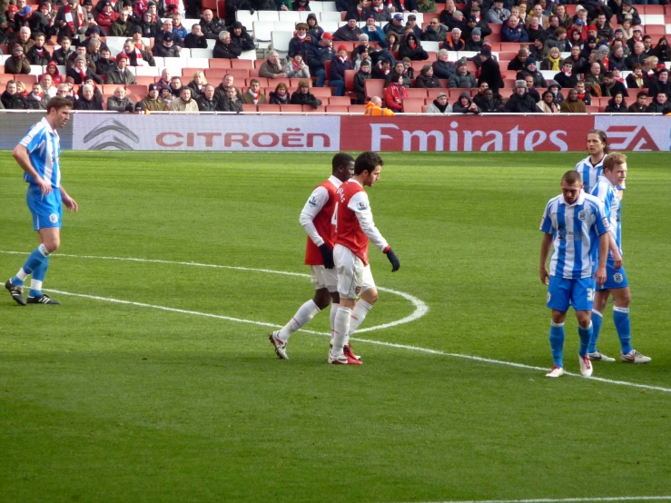 a couple of men are playing soccer on the field