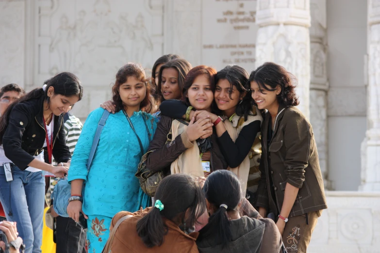 four young ladies taking pictures of themselves