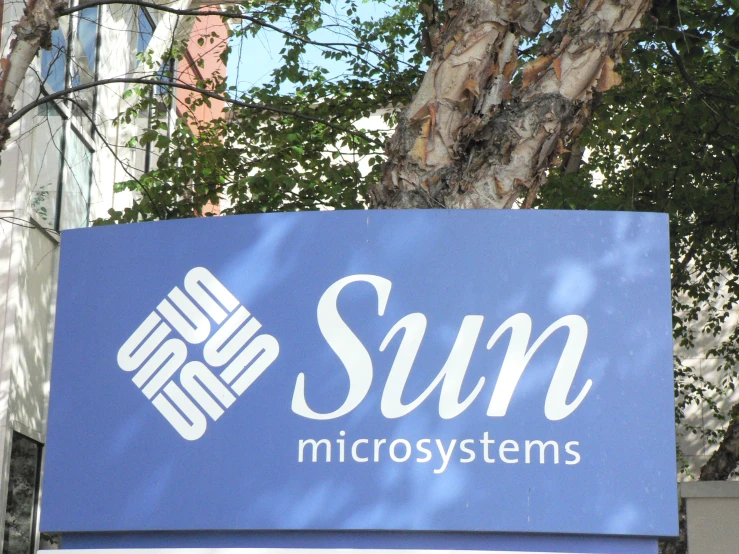 sun micro systems sign on street with buildings in background